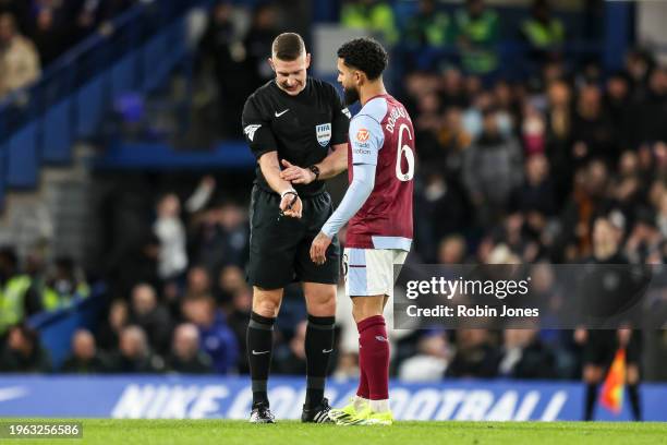 Referee Robert Jones explains to Douglas Luiz of Aston Villa that after a VAR check his first half goal was ruled out for handball during the...