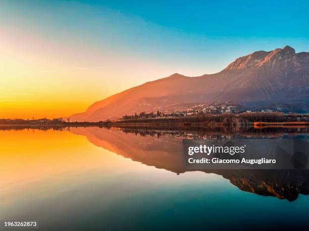 sunset in civate , lecco province , lombardy , italy - spiegelteich stock-fotos und bilder