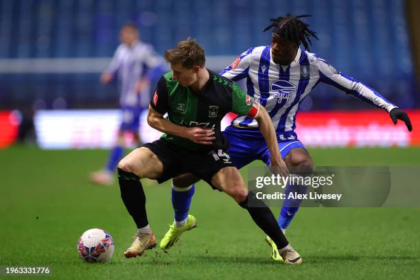 Ben Sheaf of Coventry City is challenged by Ike Ugbo of Sheffield Wednesday during the Emirates FA Cup Fourth Round match between Sheffield Wednesday...