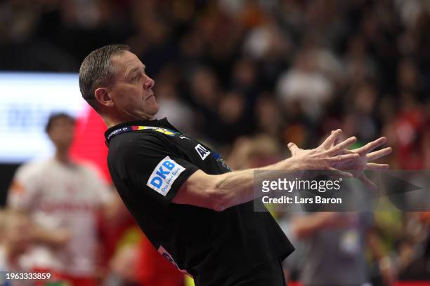 Alfred Gislason, head coach of Germany reacts during the Men's EHF Euro 2024 second semi-final match between Germany and Denmark at Lanxess Arena on...
