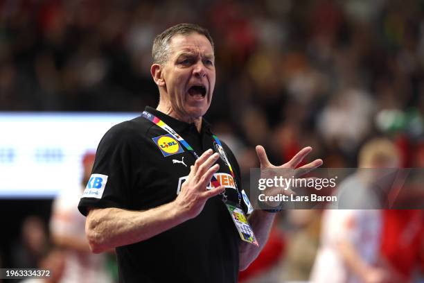 Alfred Gislason, head coach of Germany reacts during the Men's EHF Euro 2024 second semi-final match between Germany and Denmark at Lanxess Arena on...