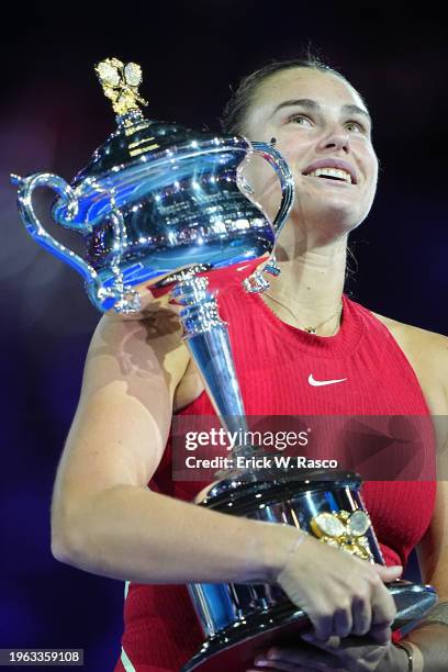 Australian Open: Aryna Sabalenka of Belarus in action, poses with the Daphne Akhurst Memorial Cup following victory vs Qinwen Zheng of China during a...