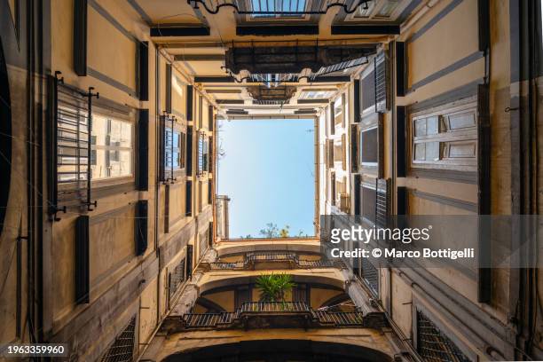low wide angle view of historical residential house inner court yard in naples, italy - trapezoid stock pictures, royalty-free photos & images