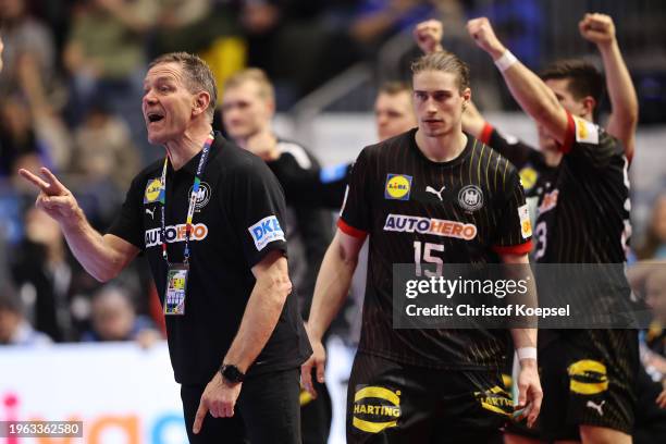 Alfred Gislason, head coach of Germany reacts with his player Juri Knorrduring the Men's EHF Euro 2024 second semi-final match between Germany and...