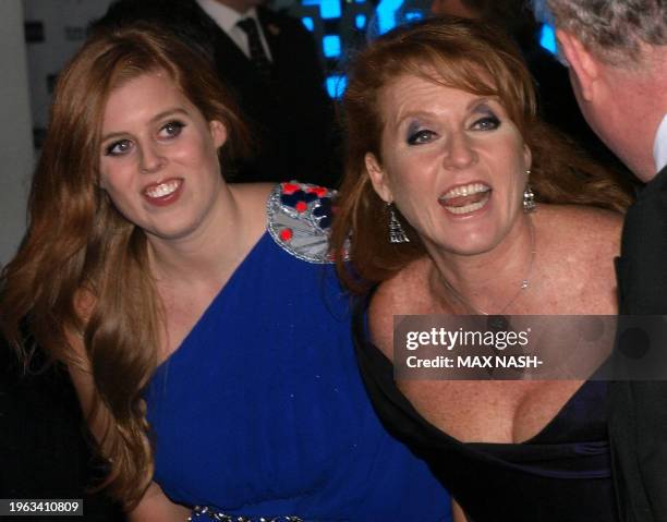 Britain's Duchess of York and daughter Beatrice joke with screenwriter Julian Fellowes as they arrive for the world premiere of the film 'The Young...