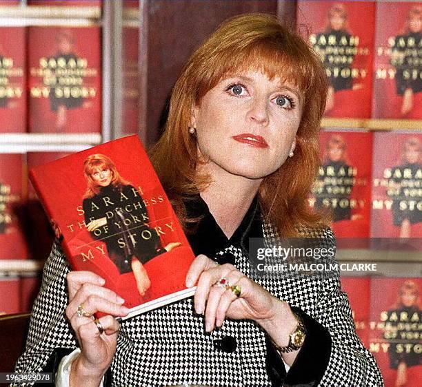 Sarah Ferguson, the Duchess of York, holds up a copy of her autobiography 14 November at a Manhattan bookstore in New York. Ferguson is divorced from...