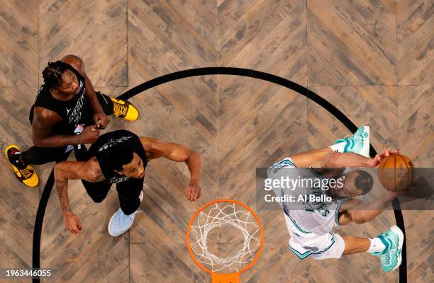 Rudy Gobert of the Minnesota Timberwolves dunks against Nic Claxton of the Brooklyn Nets and Cameron Johnson of the Brooklyn Nets during their game...