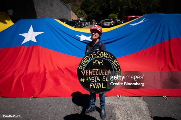 An attendee holds a sign during a press conference with Maria Corina Machado, Venezuelan opposition's presidential candidate, not pictured, in...