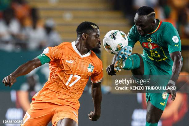 Senegal's midfielder Sadio Mane fights for the ball with Ivory Coast's defender Serge Aurier during the Africa Cup of Nations 2024 round of 16...