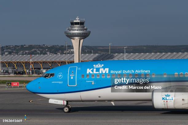 Passenger flight of KLM Royal Dutch Airlines in a runway at Adolfo Suarez Madrid-Barajas Airport passing by the control tower. The President of the...