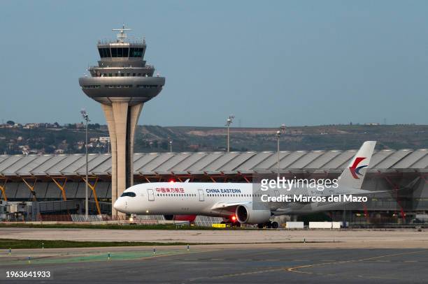 Passenger flight of China Eastern in a runway at Adolfo Suarez Madrid-Barajas Airport passing by the control tower. The President of the Government...