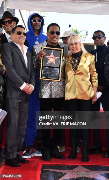 Singer/songwriter Charlie Wilson and wife Mahin Wilson pose with guests during Wilson's Hollywood Walk of Fame star ceremony on January 29, 2024 in...