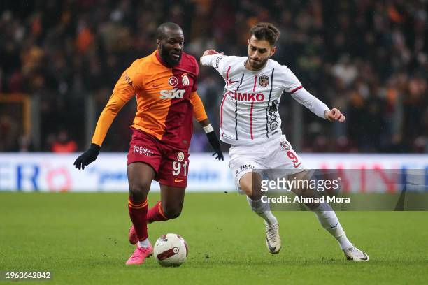 Tanguy Ndombele of Galatasaray is challenged by lker Karakas during the Turkish Super League match between Galatasaray and Gaziantep at Rams Park on...