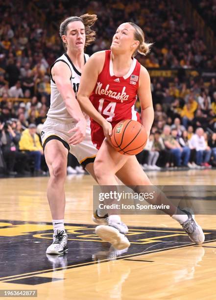 Iowa guard Caitlin Clark tries to tie up Nebraska guard Callin Hake as she drives to the basket during a women's college basketball game between the...