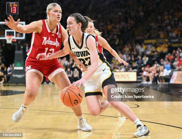 Iowa guard Caitlin Clark drives to the basket as Nebraska forward Jessica Petrie defends during a women's college basketball game between the...