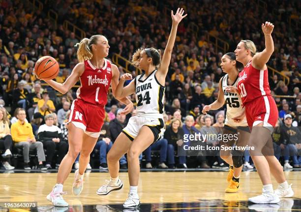 Nebraska guard Jay Shelley looks to pass as Iowa guard Gabby Marshall defends during a women's college basketball game between the Nebraska...