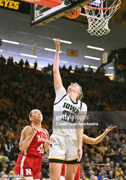 Iowa guard Kate Martin puts up a shot over Nebraska center Alexis Markowski during a women's college basketball game between the Nebraska Cornhusker...