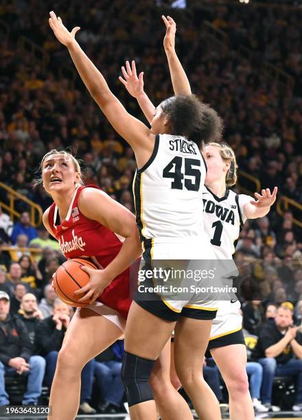 Nebraska center Alexis Markowski attempts a shot as Iowa forward Hannah Stuelke defends during a women's college basketball game between the Nebraska...