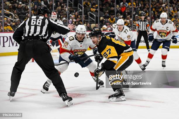 Florida Panthers center Sam Reinhart and Pittsburgh Penguins center Sidney Crosby face-off during the second period in the NHL game between the...