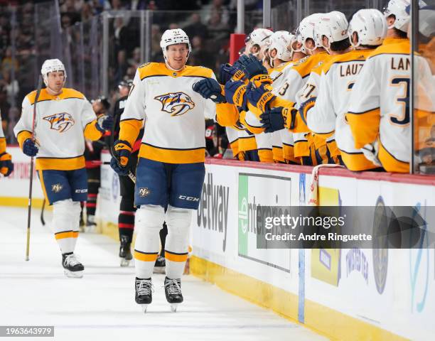 Michael McCarron of the Nashville Predators celebrates his first period goal against the Ottawa Senators with teammates at the players' bench at...