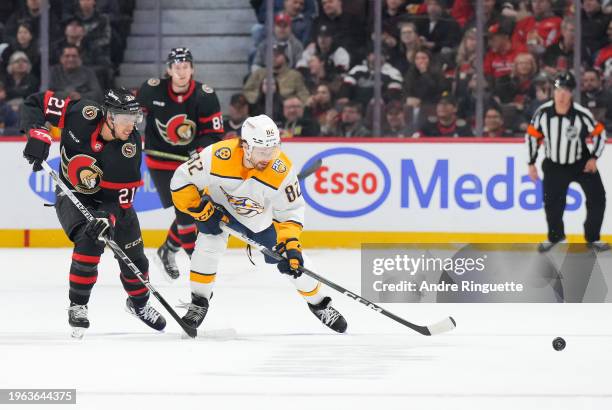 Mathieu Joseph of the Ottawa Senators battles for puck possession against Tommy Novak of the Nashville Predators during the first period at Canadian...