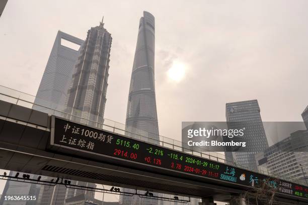 An electronic ticker displays stock figures in Pudong's Lujiazui Financial District in Shanghai, China, on Monday, Jan. 29, 2024. China will halt the...