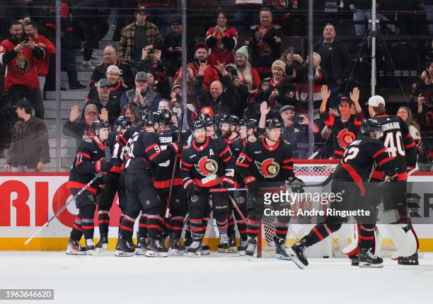 Claude Giroux of the Ottawa Senators celebrates his game winning overtime goal against the Nashville Predators with teammates at Canadian Tire Centre...