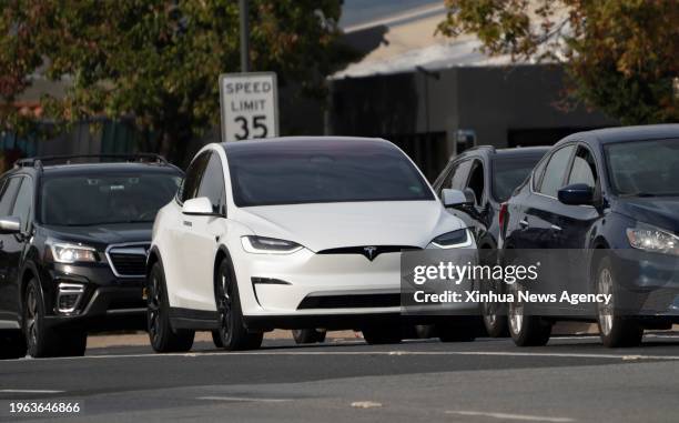 Tesla car runs in San Mateo County, California, the United States, Dec. 13, 2023. Tesla said on Wednesday the company is recalling more than 2...