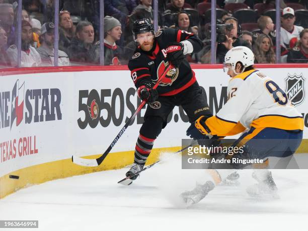 Claude Giroux of the Ottawa Senators passes the puck against Tommy Novak of the Nashville Predators during the third period at Canadian Tire Centre...