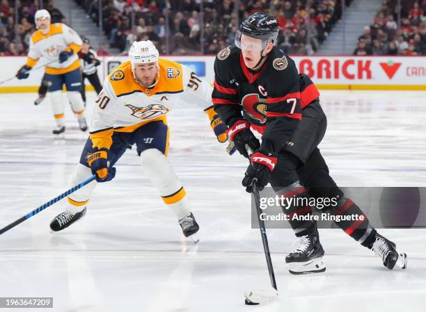 Brady Tkachuk of the Ottawa Senators controls the puck against Ryan O'Reilly of the Nashville Predators during the third period at Canadian Tire...