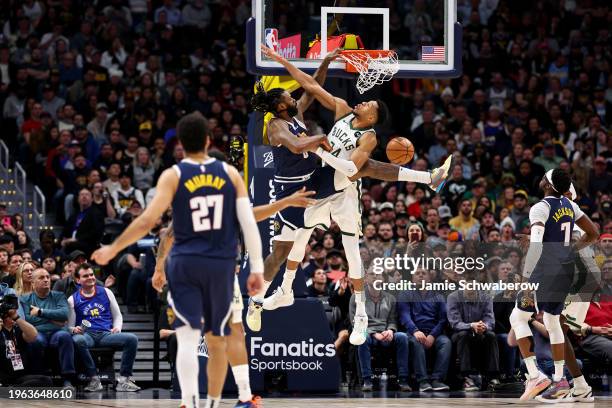 DeAndre Jordan of the Denver Nuggets dunks over Giannis Antetokounmpo of the Milwaukee Bucks at Ball Arena on January 29, 2024 in Denver, Colorado....