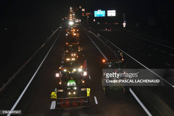 Farmers drive their tractors on the A20 highway near Limoges, on January 30 on their way to Rungis wholesale food market amid nationwide protests...