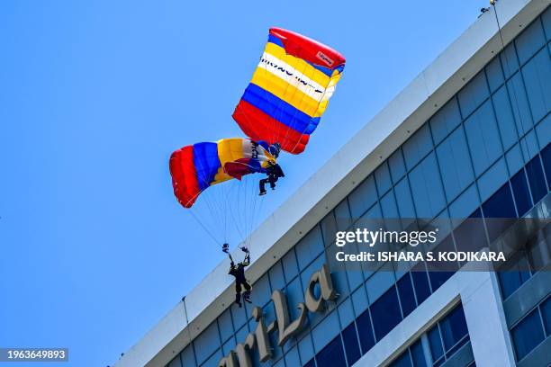 Sri Lankan paratroopers entangle during the Independence Day parade rehearsal in Colombo on January 30 troopers got injured after crashing onto a...