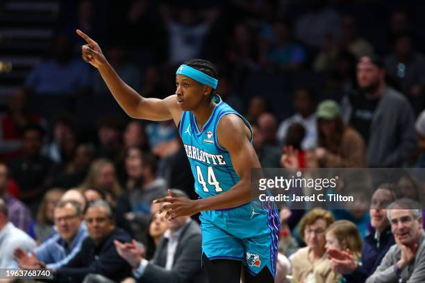 Frank Ntilikina of the Charlotte Hornets reacts following a three point basket during the first quarter of the game against the Houston Rockets at...