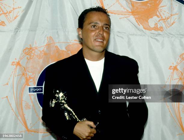 English singer Curt Smith, of the English pop rock band Tears For Fears, poses with an MTV Moonman award during the 1990 MTV Video Music Awards at...