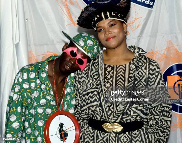 American rappers Flavor Flav and Queen Latifah pose for a portrait backstage during the 1990 MTV Video Music Awards at the Universal Amphitheatre in...