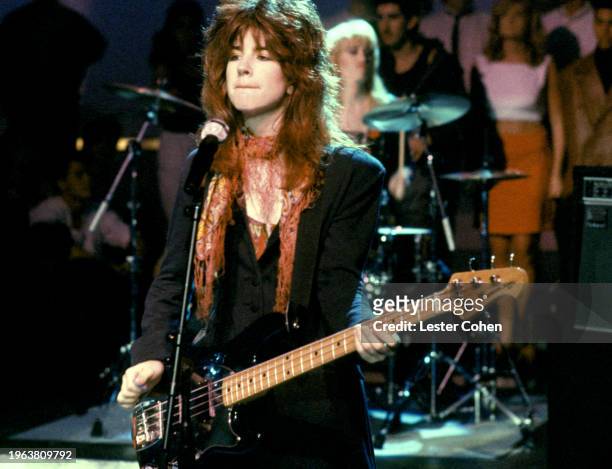 American bassist, guitarist, songwriter, and singer Michael Steele, of the American pop rock band The Bangles, sings on stage during an appearance on...