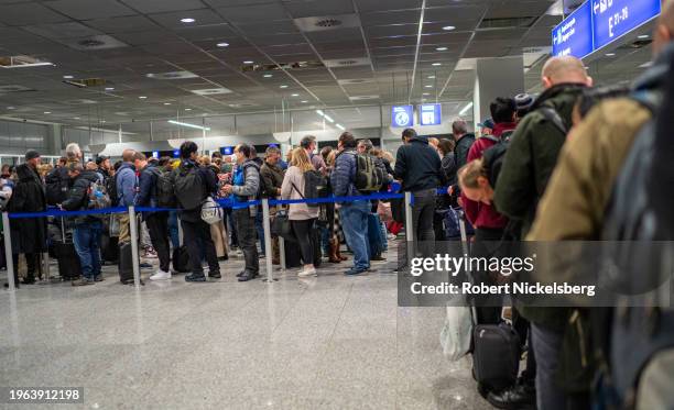 Arriving passengers stand in line at the immigration clearance area on January 21, 2024 at the Frankfurt Airport in Frankfurt, Germany.