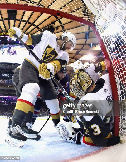 Nicolas Hague and Adin Hill of the Vegas Golden Knights defend against Blake Wheeler of the New York Rangers during the third period at Madison...