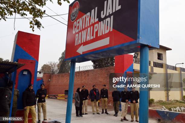 Police personnel stand outside the entrance of Adiala jail during the hearing of jailed former Pakistan's Prime Minister Imran Khan, in Rawalpindi on...