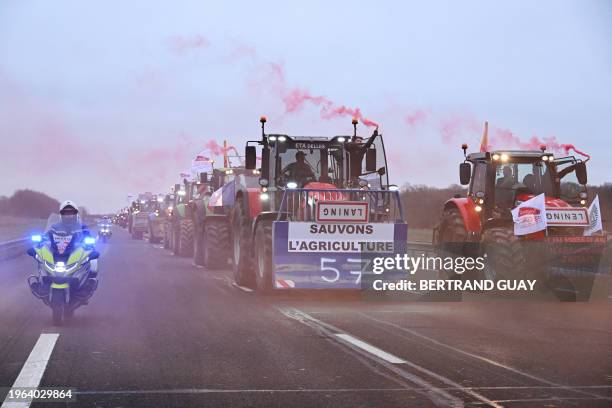 Farmers riding their tractor displaying a banner which reads as "Let's save agriculture" and roadsigns turned upside down, coming from Meuse and...