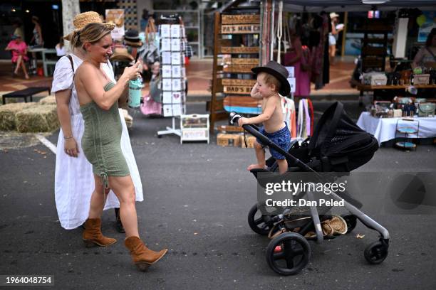 Mother attempts to take a photo of her young son with a cowboy hat on January 27, 2024 in Tamworth, Australia, during the Country Music Festival....