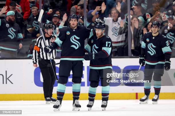 Brian Dumoulin of the Seattle Kraken celebrates his goal with Jaden Schwartz during the first period against the St. Louis Blues at Climate Pledge...