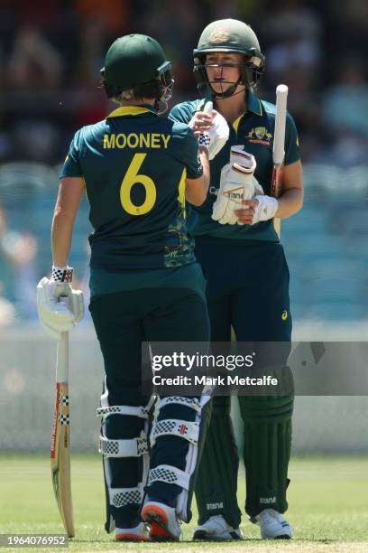 Beth Mooney and Ellyse Perry of Australia celebrate victory during game one of the Women's T20 International series between Australia and South...