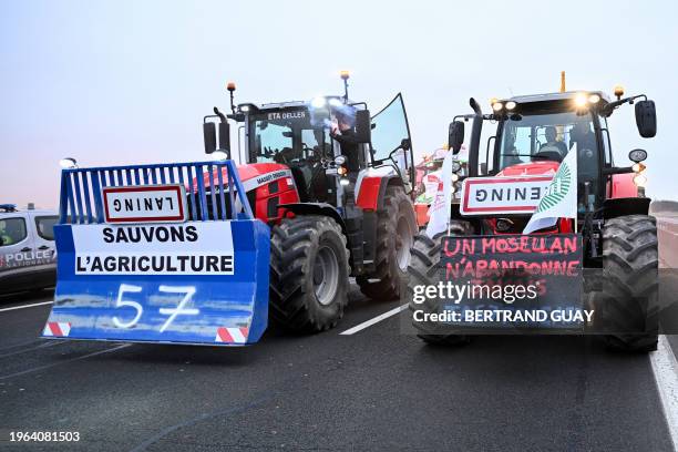 Police vehicle is parked next to farmers in their tractor coming from Meuse and Moselle and displaying banners which read as "let's save agriculture"...