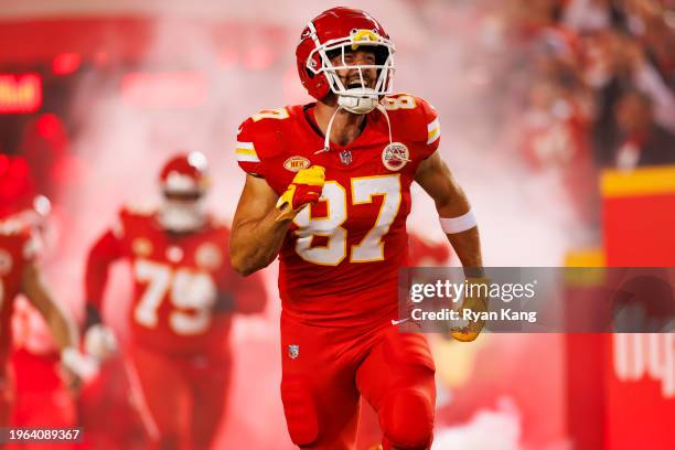 Travis Kelce of the Kansas City Chiefs celebrates as he runs onto the field during team entrances prior to an NFL football game against the Denver...