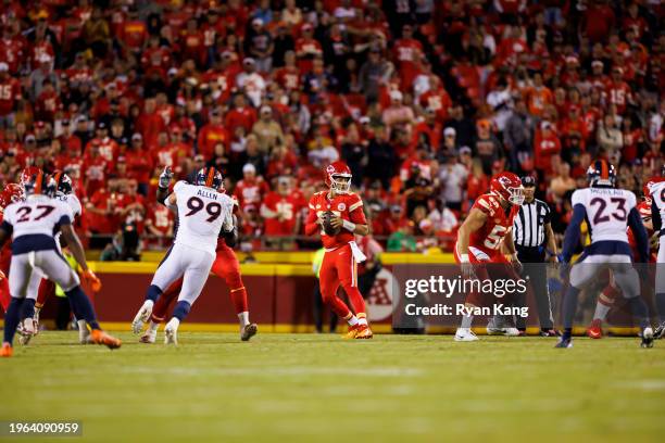 Patrick Mahomes of the Kansas City Chiefs drops back and looks to throw a pass during an NFL football game against the Denver Broncos at GEHA Field...