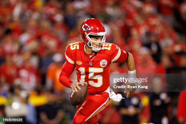 Patrick Mahomes of the Kansas City Chiefs rolls out and looks to throw a pass during an NFL football game against the Denver Broncos at GEHA Field at...