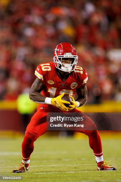 Isiah Pacheco of the Kansas City Chiefs runs the ball after a catch during an NFL football game against the Denver Broncos at GEHA Field at Arrowhead...