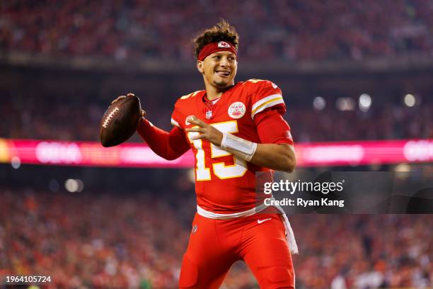 Patrick Mahomes of the Kansas City Chiefs looks to throw a pass on the sideline prior to an NFL football game against the Denver Broncos at GEHA...